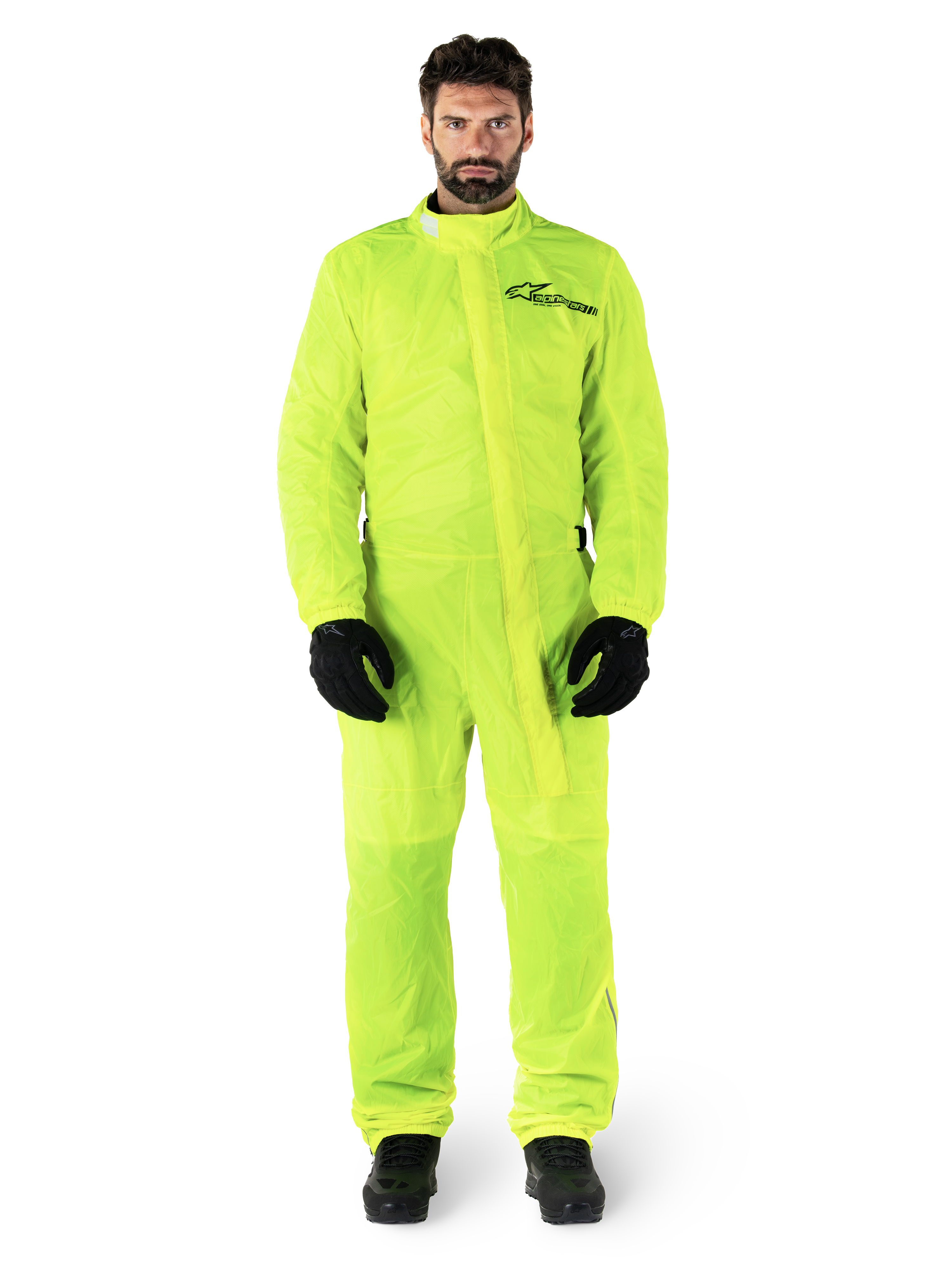 Alpinestars Hurricane Rain V2 Suit, Motorcycle Rain Suit, Yellow Fluo, male model wearing full-body protection with black gloves and boots, high collar with front storm flap, reflective logo on chest, high-visibility waterproof gear
