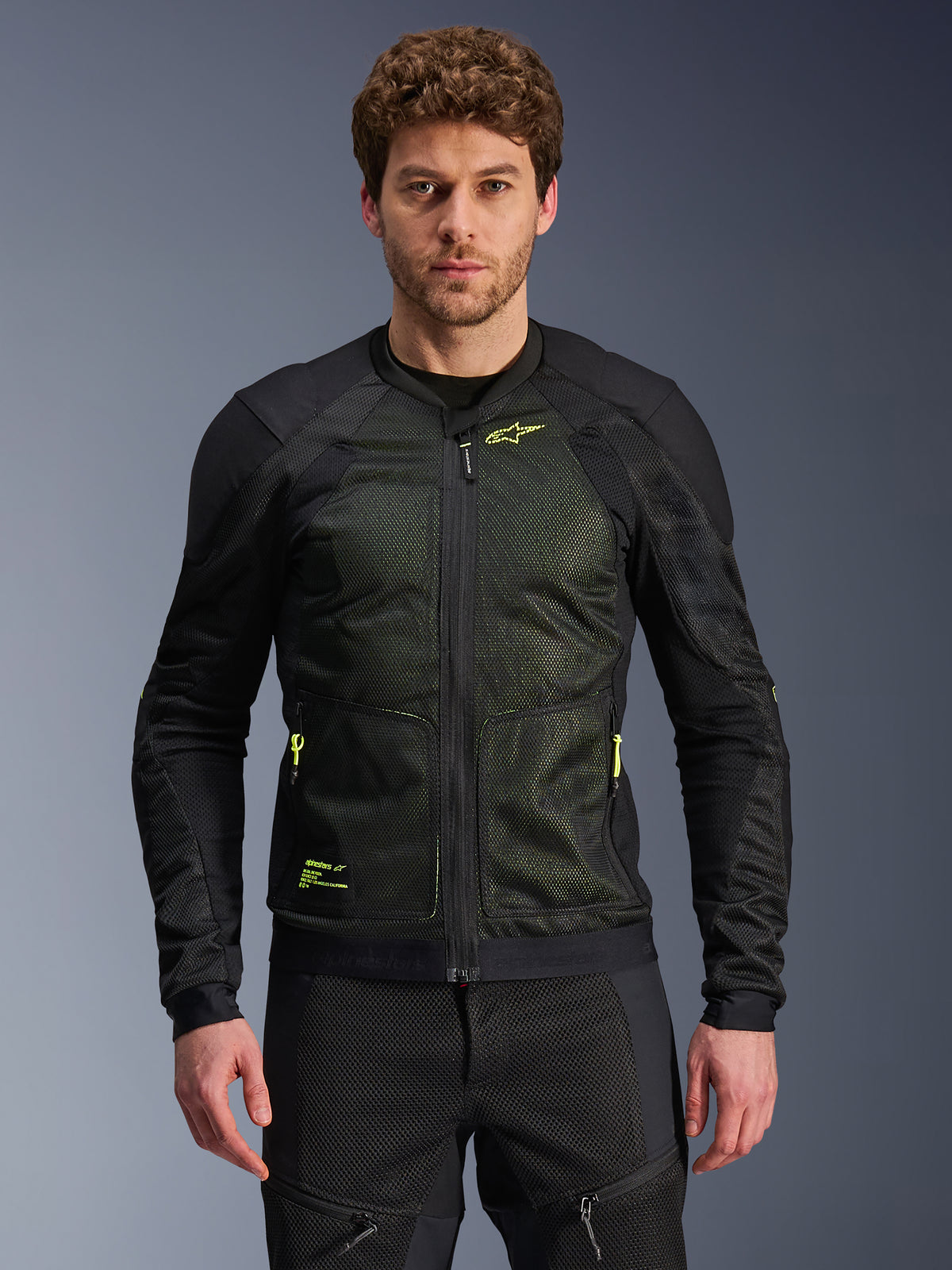 Alpinestars Troop-Air Jacket, Black and Yellow Fluo, worn by male model, featuring lightweight mesh construction, neon yellow zippers and branding, technical ventilated motorcycle jacket for urban riding