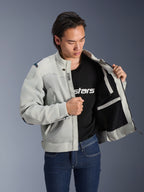 Alpinestars Circal-1 Air Jacket, Metal Gray, held open to show interior mesh lining and pocket details, worn by a model with a black logo t-shirt and blue jeans, urban motorcycle style