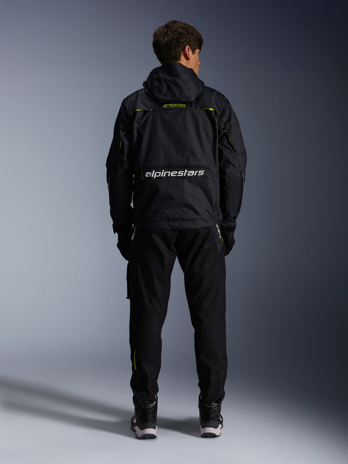 Alpinestars Mogress Air Jacket, black and lime punch textile urban motorcycle jacket, back view with white branding.