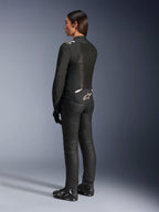 Alpinestars Stella T-Sps Air V2 Jacket, Black and White, back view showing mesh panels and logo on the lower back, paired with black riding pants and motorcycle shoes, sporty textile road gear for women