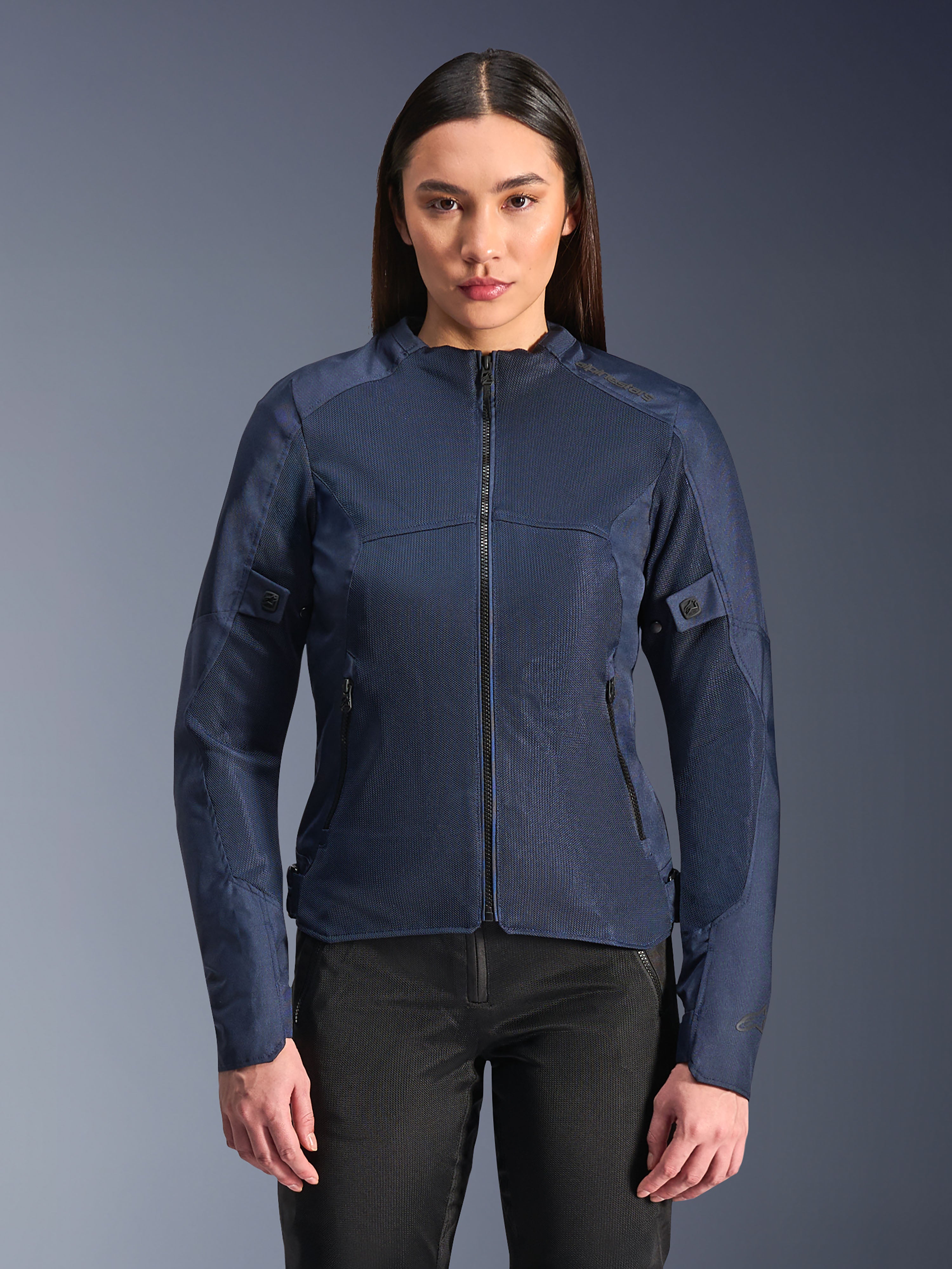 Alpinestars Stella C-1 Air Jacket in Blue, Women's Motorcycle Jacket, modeled with black riding pants, features large mesh panels for airflow, zippered front and side pockets, and a clean contemporary design.