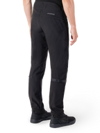 Pantalon Alpinestars Alden, pantalon de moto urbain, noir, vue arrière montrant le tissu softshell technique avec des détails matelassés, marquage réfléchissant MO.ST.EQ. sur l'empiècement arrière et sangles de mollet réglables, associé à des chaussures de moto noires