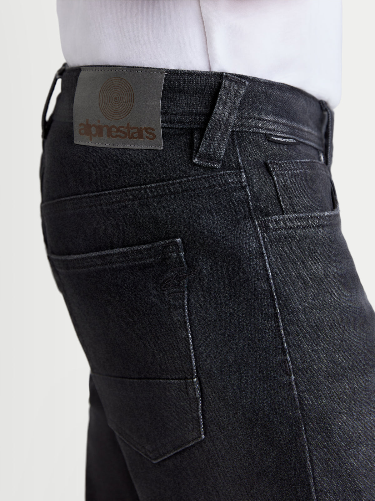 Alpinestars Flex-AST 8 Denim Pants, urban motorcycle riding jeans, used black, close-up view highlighting the leather back patch and rear pockets on a model