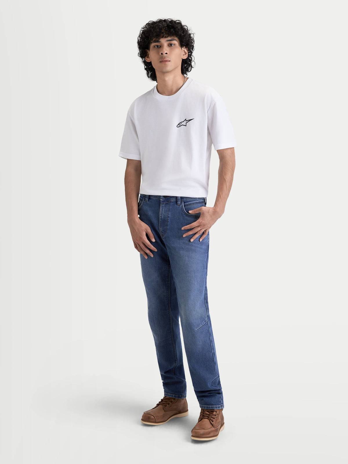 Alpinestars Flex-AST 7 Denim Pants, men's urban contemporary motorcycle riding jeans in light blue, front full view on a model wearing a white t-shirt and brown boots, AA-rated single-layer protective denim with COOLMAX comfort