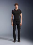 Alpinestars Copper V3 Denim broek in Black Rinse, regular comfort straight-leg pasvorm, gedragen door een mannelijk model met een zwart base layer t-shirt voorzien van rode contraststiksels en zwarte motorsneakers, stedelijke motoruitrusting ensemble