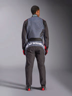 Alpinestars KMX-9 V3 Graphic 6 Suit, Karting Suit, Anthracite Black and Red, rear view showing large white Alpinestars branding across the lower back, gray upper body with black splatter graphics, black arms and legs, worn with red and black racing gloves and boots.