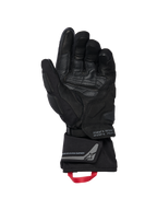 Gants isolés Alpinestars WT-8 GORE-TEX, gants de moto, noirs, vue de la paume intérieure montrant des empiècements en cuir renforcé et des protections rembourrées, manchette longue avec boucle de tirage rouge et marquage Alpinestars Exploration Equipment avec coordonnées géographiques, design technique pour la route et l'aventure