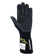 Gants Alpinestars Tech-1 ZX V4, gants de course automobile, gris goudron et noir avec logo jaune fluo, vue de la paume montrant le grip en silicone 3D texturé et les étiquettes d'homologation FIA/SFI, équipement professionnel de sport automobile