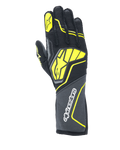 Gants Alpinestars Tech-1 ZX V4, gants de course automobile, gris goudron, noir et jaune fluo, dotés d'un grand logo étoile jaune au dos et d'un marquage blanc sur la manchette, tissu à structure alvéolée avec des accents néon angulaires, équipement professionnel de sport automobile.