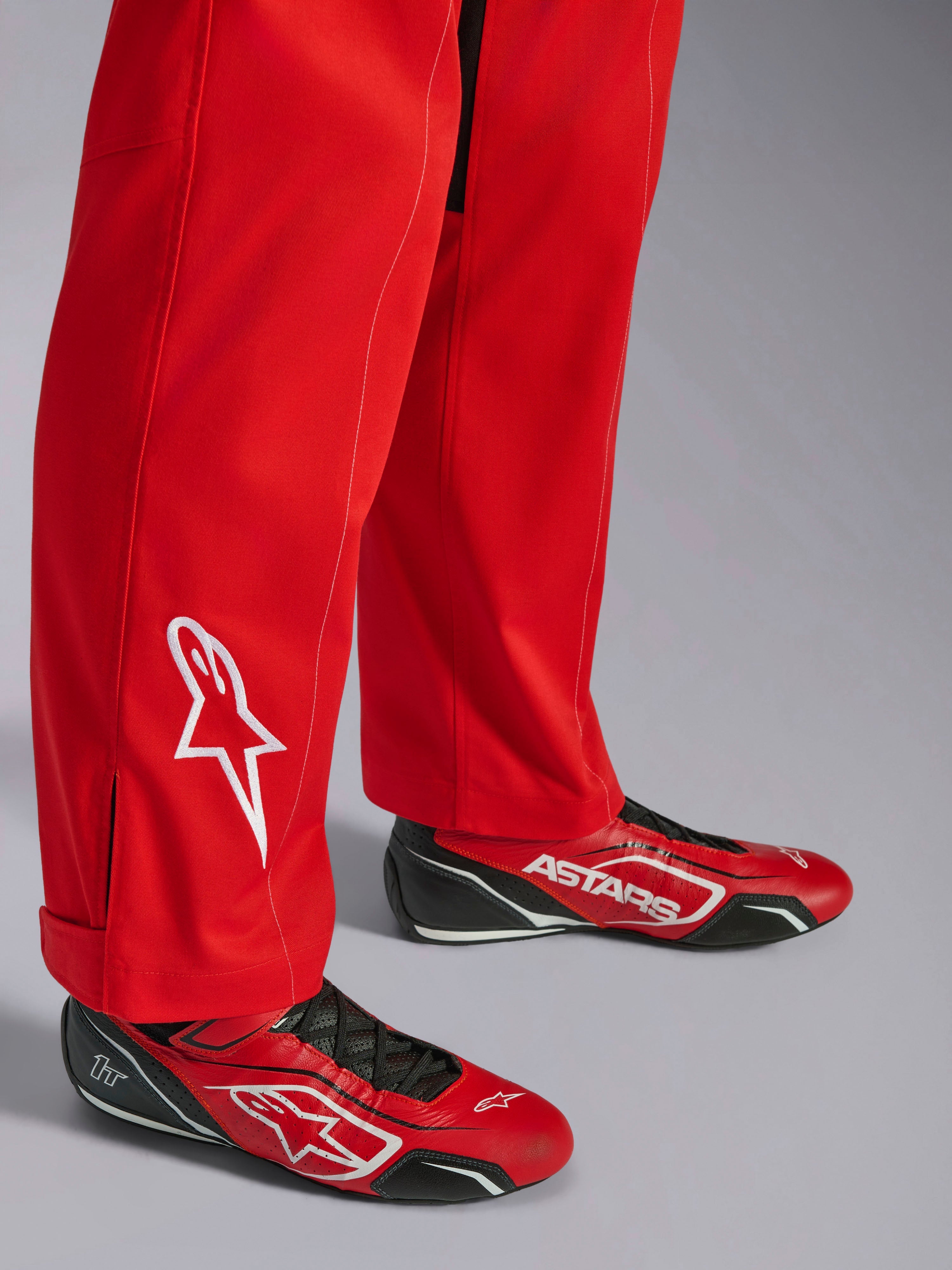 Alpinestars Kart Indoor V2 Suit, Red, lower leg detail with white embroidered star logo, worn with matching red and black karting shoes, single-layer poly-cotton twill material for recreational racing