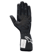 Alpinestars Tech-1 Race V4 handschoenen, professionele autorace-handschoenen, Black Tar Gray, weergave van de palmzijde met uitgebreide siliconen grippatronen op de vingers en palm, verlengde manchet met wit Alpinestars-logo en FIA/SFI-certificeringslabels