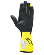 Gants Alpinestars Tech-1 Race V4, gants de course automobile, noir et jaune fluo, vue de la paume avec grip en silicone texturé, manchette jaune étendue avec étiquette d'homologation FIA, équipement de sport automobile haute performance