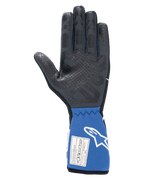 Gants Alpinestars Tech-1 Race V4, noir et bleu, vue de la paume intérieure montrant le motif d'adhérence en silicone texturé, manchette bleue allongée avec étiquette d'homologation FIA et logo Alpinestars blanc, équipement professionnel de course automobile