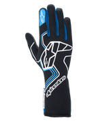 Gants Alpinestars Tech-1 Race V4, gants de course automobile, noirs avec accents bleus et blancs, dotés d'un grand logo blanc sur le dos de la main, de liserés bleus sur les doigts et d'une manchette longue, conception ignifugée professionnelle pour le sport automobile