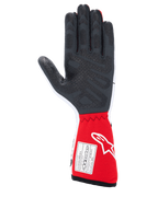 Gants Alpinestars Tech-1 Race V4, gants de course automobile, blanc et rouge, vue de la paume présentant des motifs d'adhérence en silicone noir texturé et une étiquette d'homologation FIA 8856-2018 sur la manchette rouge, équipement de sport automobile professionnel