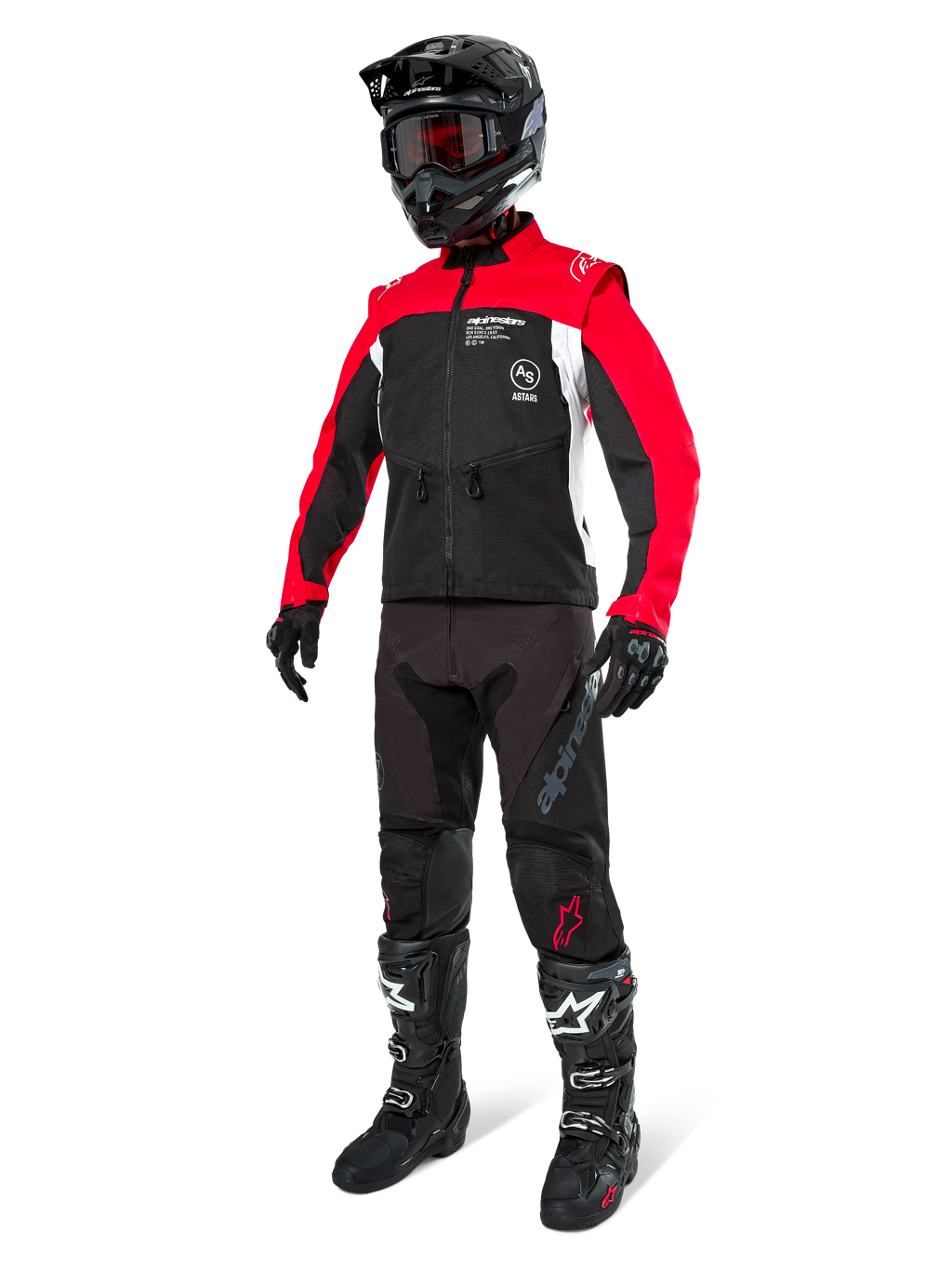 Alpinestars Pro-Dura jas, off-road motorjas, zwart met felrood en wit, gedragen met volledige race-uitrusting inclusief zwarte helm met rode bril, zwarte broek en zwart-witte laarzen, duurzame textiele outfit voor enduro en trailrijden