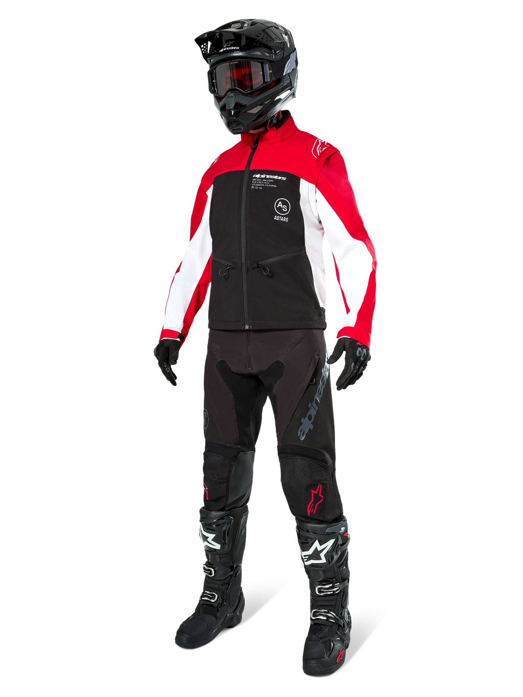 Pilote de motocross portant la veste Alpinestars Lite-Dura Softshell en noir, rouge vif et blanc, avec corps noir et manches rouges et blanches, pantalon noir, casque noir avec lunettes rouges et bottes noires et blanches, tenue de course tout-terrain complète