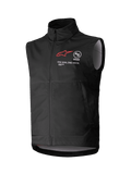 Gilet Softshell Techstar Alpinestars, gilet de motocross noir sans manches, col montant avec fermeture éclair frontale, logo étoile rouge avec marquages "ASTARS" et "ONE GOAL. ONE VISION." sur la poitrine, tissu softshell léger et coupe-vent avec doublure gris clair, conçu pour le tout-terrain