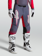 Alpinestars Supertech Hiten AFD broek, motocrossbroek in grijs en rood met witte ster-graphics en magnetische gesp.