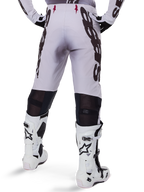 Alpinestars 2025 Supertech Maker Pants, Motocross Pants, Silver and Black, back view showing large black logos on thighs and breathable mesh zones behind the knees, worn with white Alpinestars boots.