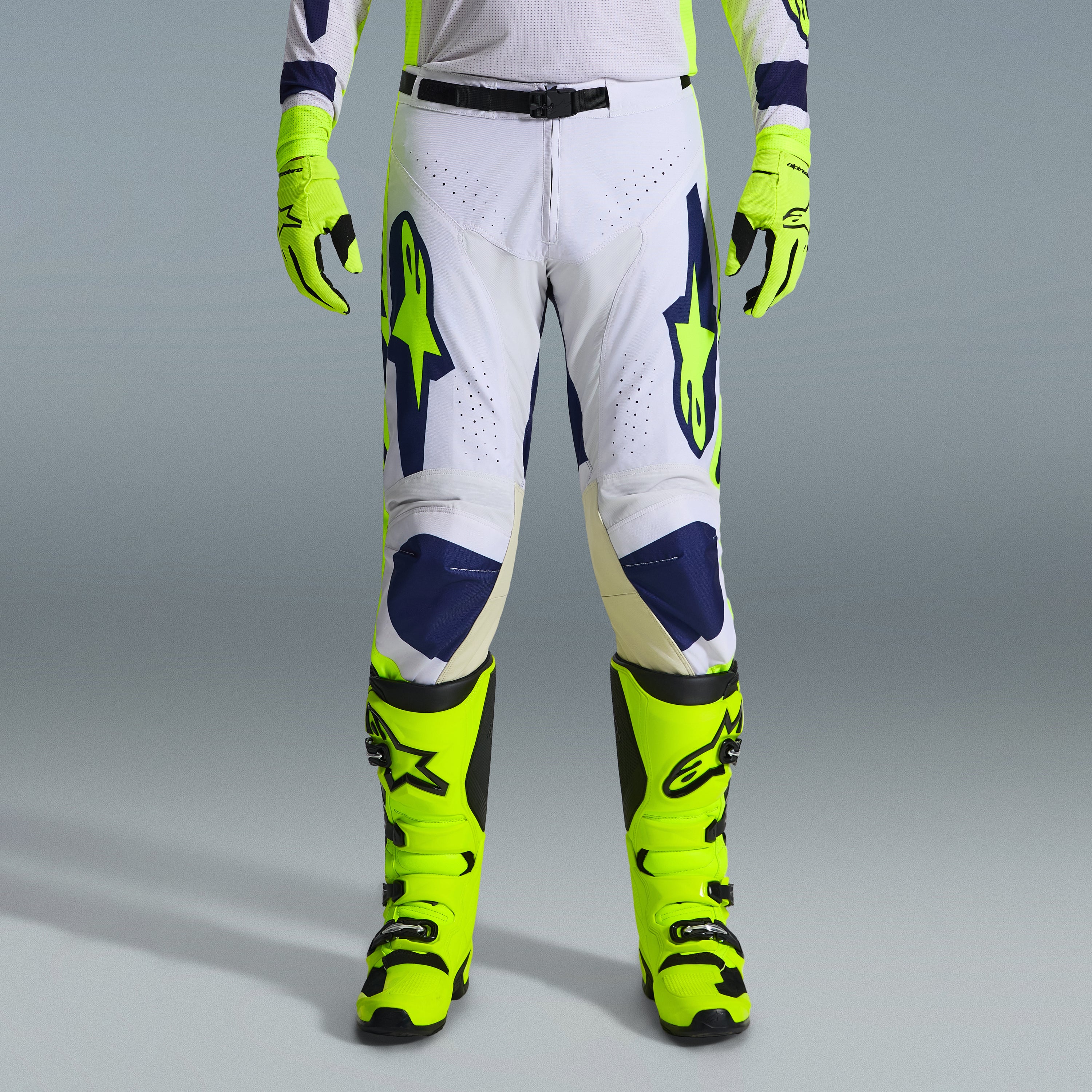 Alpinestars 2026 Racer Air Riway Gear Set, Motocross Pants in White and Navy Blue with Neon Yellow accents, paired with matching neon yellow gloves and boots, featuring ergonomic design and ventilated panels for off-road racing.