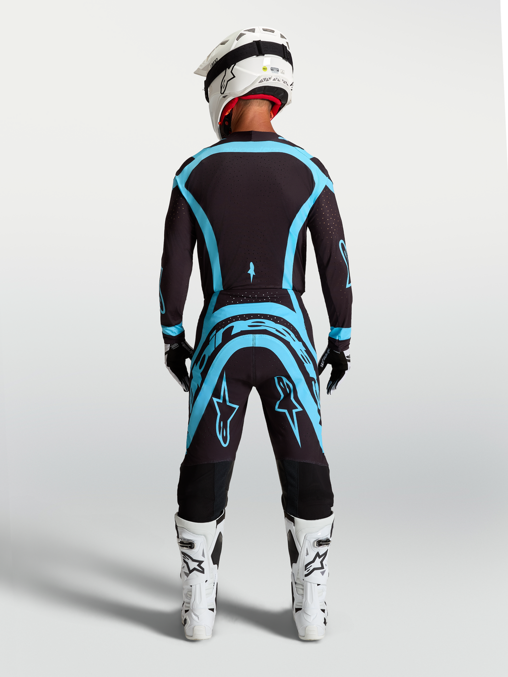 Alpinestars Supertech Vesta broek in zwart en turquoise, professionele motocrossuitrusting met een atletische pasvorm.