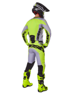 Alpinestars 2025 Racer Veil Pants, Motocross Pants, Gray and Fluorescent Yellow, rear view of rider in full gear, matching jersey and fluo yellow boots, featuring bold black logos, technical off-road racing kit.