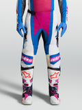 Alpinestars Techstar Maven, pantalon de motocross blanc et bleu avec accents corail, panneaux de genoux en cuir et zones ventilées, idéal pour le pilotage tout-terrain