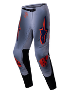 Alpinestars Supertech Lipan Pants 2025, pantalon de motocross, gris et orange fluo, avec logos étoiles orange vif et bleu marine sur les cuisses et les genoux, panneaux intérieurs noirs et ceinture ajustable, conçu pour des performances tout-terrain de niveau professionnel