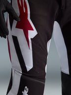 Alpinestars 2026 Supertech AFD Vista Pants, Motocross Pants, Black Red and White, close-up of the thigh area featuring a large red and white star logo, laser-cut perforations for airflow, and durable stretch ripstop fabric.