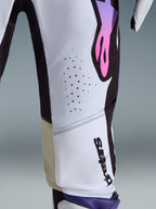 Close-up of the 2026 Supertech AFD Vista Pants, White Purple Black, showing the laser-cut perforations for ventilation, inner knee goat leather panels, and purple-to-pink gradient logo on a white and black chassis, professional motocross racing apparel.