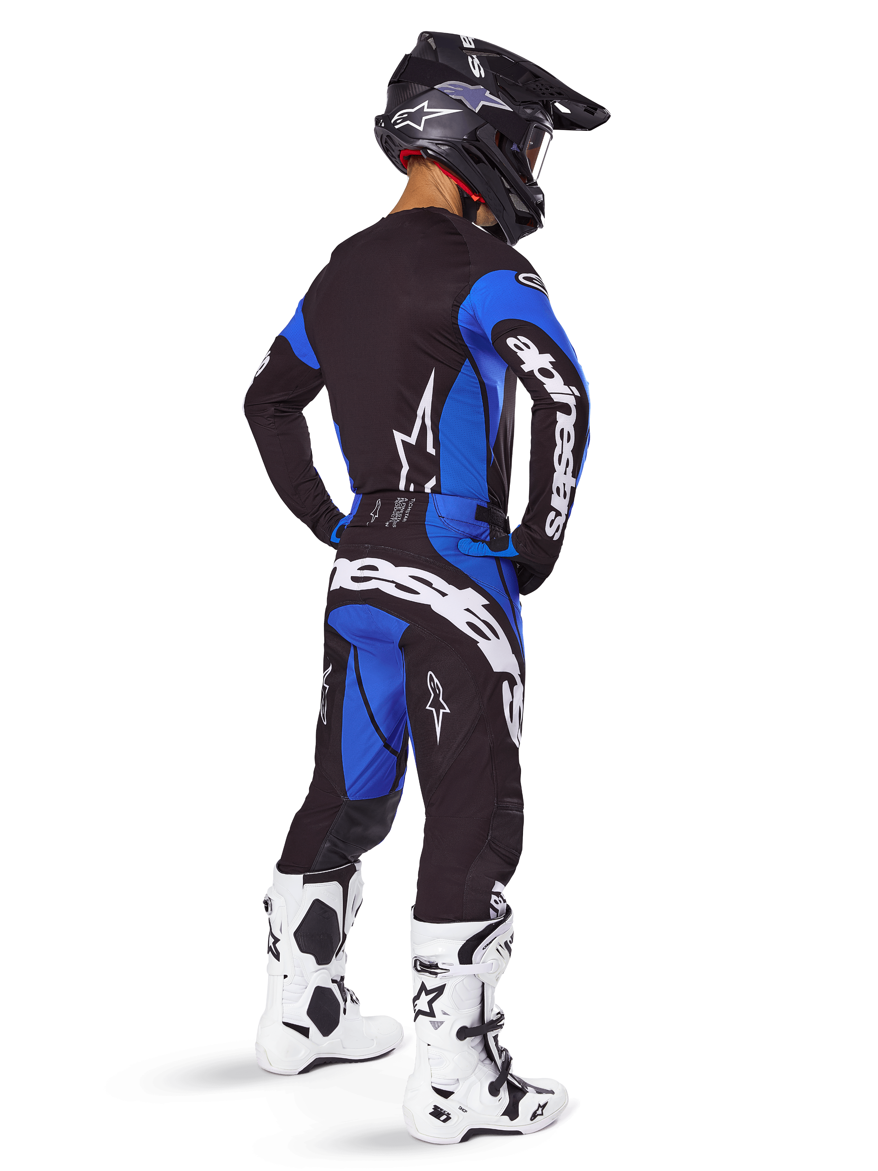 Pantalon Alpinestars Techstar Dreem 2025, pantalon de motocross, noir et bleu, porté par un pilote avec un équipement complet comprenant un maillot assorti, un casque noir et des bottes blanches, arborant un logo blanc imposant à l'arrière et une coupe de course axée sur la performance.