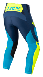 Alpinestars Techstar Factory broek, motorcross broek, donkerblauw, fluogeel en helderblauw neo, achterzijde met 'ASTARS' branding op de tailleband, geperforeerde mesh-panelen voor ventilatie, zwarte patches aan de binnenzijde van de benen en een voorgevormde racepasvorm voor off-road prestaties.