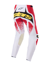 Alpinestars 2026 Techstar Nomur Pants, pantalon de motocross, blanc, rouge et noir, vue arrière avec logo 'Stars' jaune et motifs mouchetés rouges, construction multi-panneaux robuste pour la course tout-terrain