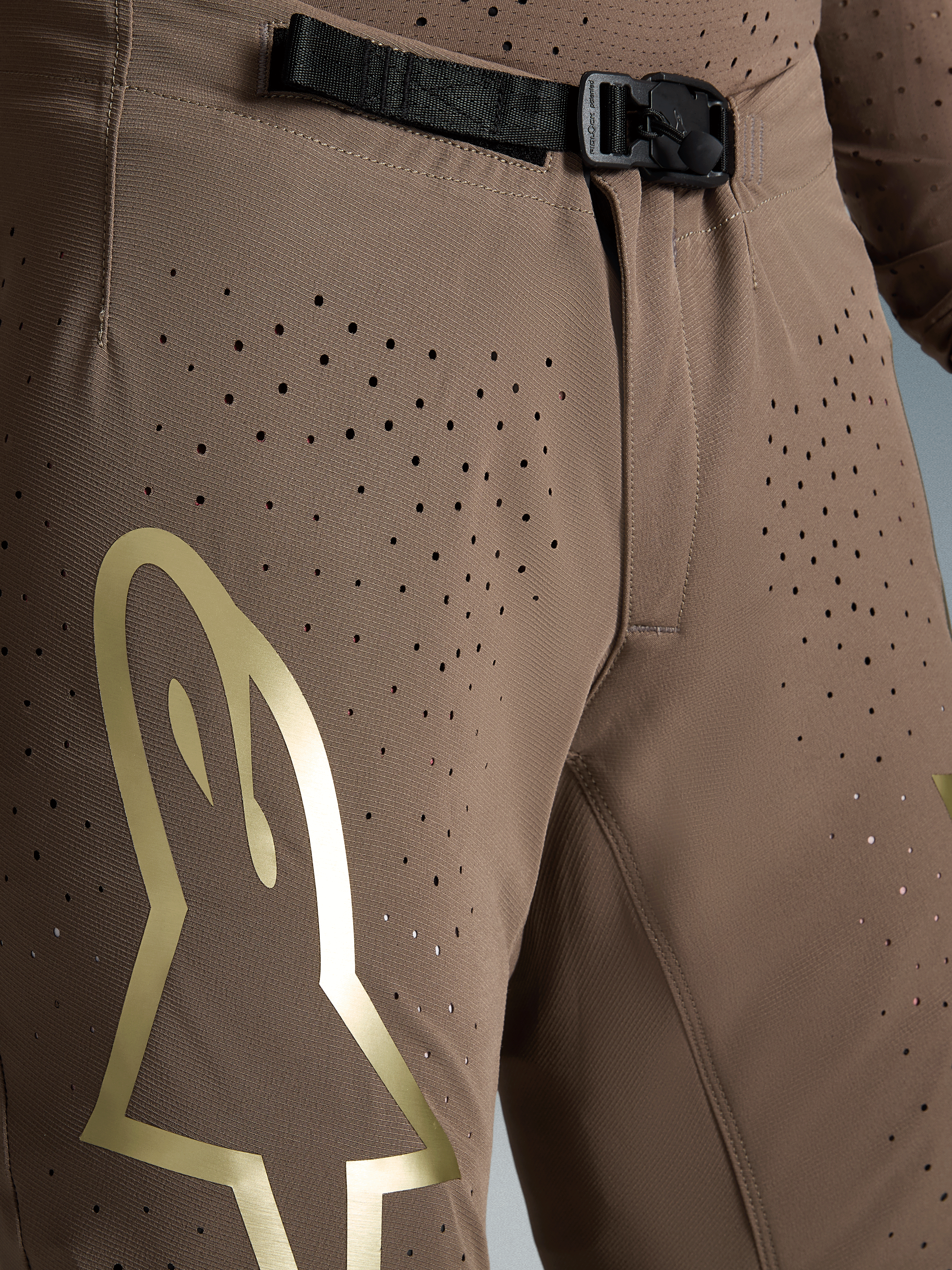 Alpinestars Limited Edition Supertech Air Gold Motocross Pants in Brown with gold logo and SX1 magnetic buckle.