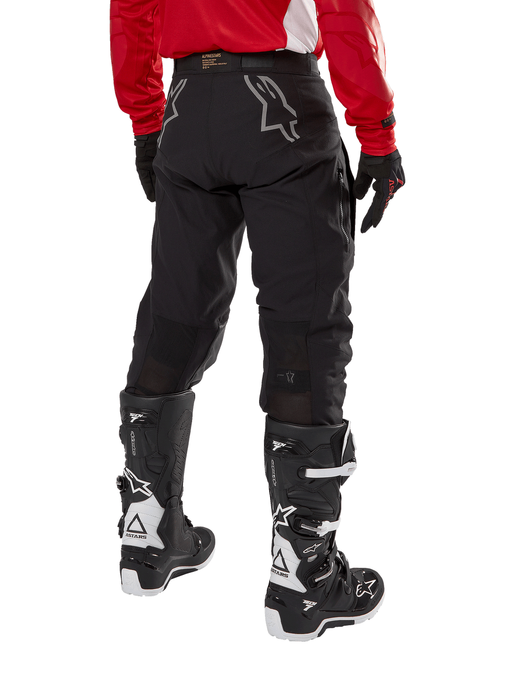 Alpinestars Techdura Pants, Off-Road Enduro Pants, Black, rear view showing gray star logos on the seat, worn with a red long-sleeve jersey and black and white Tech 7 boots, rugged textile construction for adventure riding