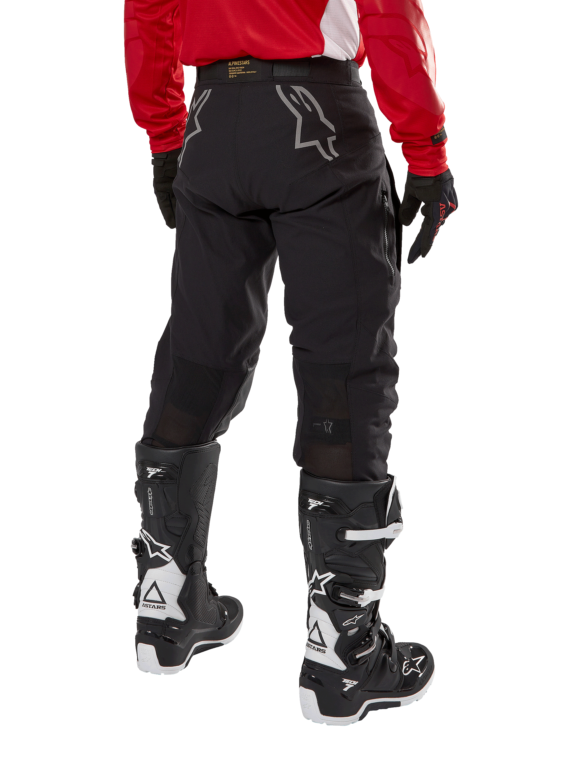 Alpinestars Techdura Pants, Off-Road Enduro Pants, Black, rear view showing gray star logos on the seat, worn with a red long-sleeve jersey and black and white Tech 7 boots, rugged textile construction for adventure riding
