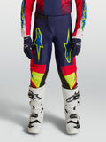 Alpinestars pantalon Fluid Drag Junior, pantalon de motocross bleu marine et rouge avec graphismes jaune néon.