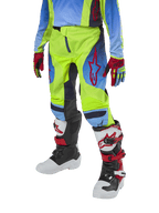 Alpinestars Youth 2024 Racer Hoen Pants, Motocross Pants, Yellow Fluo and Blue Night Navy with red accents, worn with matching gloves and white, black, and red boots, featuring a sport fit and pre-curved legs for off-road racing