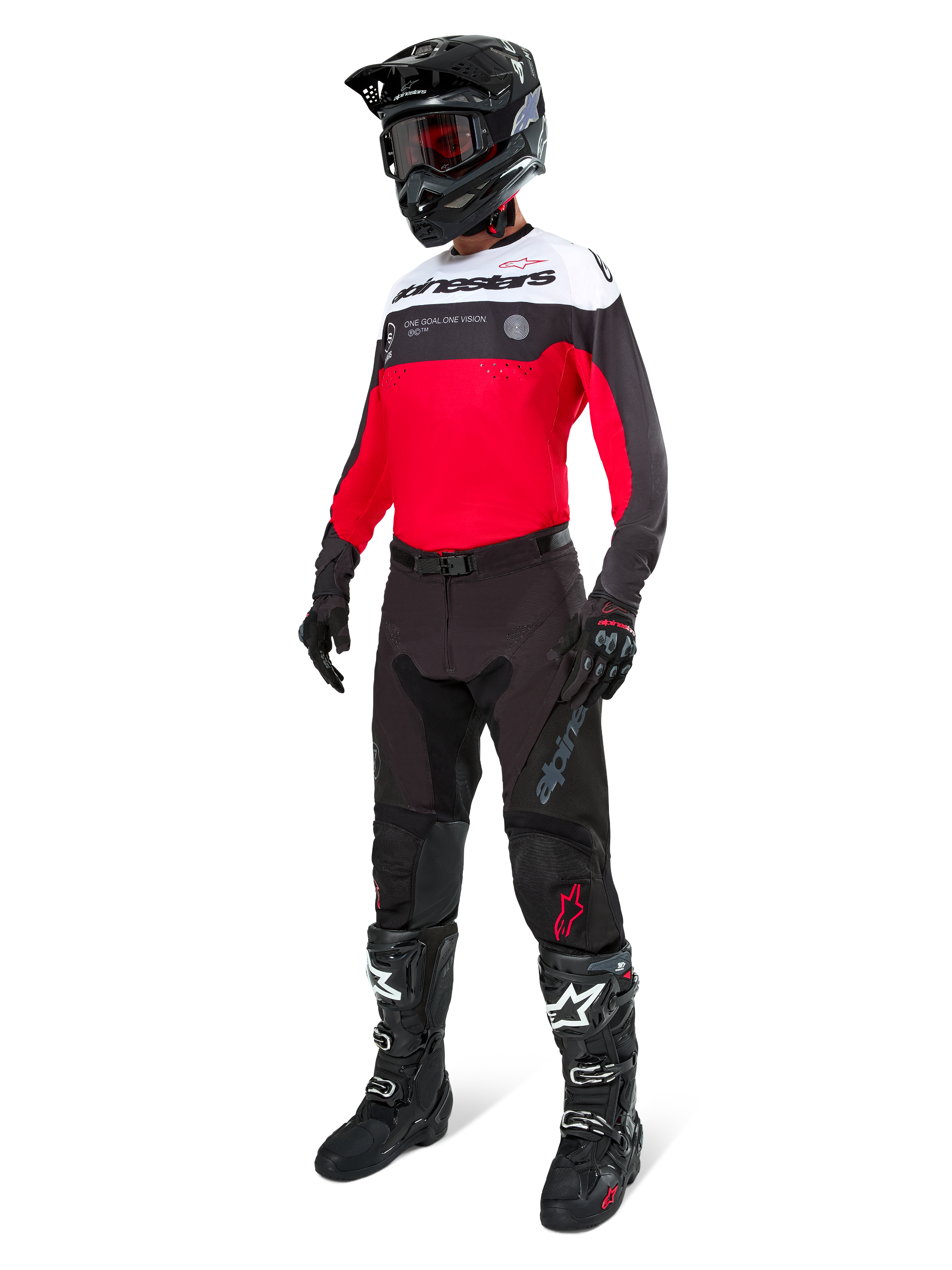 Maillot Alpinestars Pro-Dura, maillot de motocross et d'enduro, noir, rouge vif et blanc, porté avec un pantalon noir, un casque noir et des bottes noires et blanches, doté d'un marquage imposant sur la poitrine et de perforations au laser, équipement haute performance pour la conduite tout-terrain