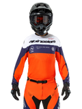 Alpinestars Pro-Dura Jersey, Motocross Jersey, Navy Blue, Hot Orange, and White, worn with a black helmet and gloves, featuring laser-perforated ventilation zones, bold branding, and "ONE GOAL. ONE VISION." chest graphic