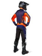 Motocross rider from the back wearing Alpinestars Pro-Dura Jersey, Navy Hot Orange and White, matching navy and orange pants, black helmet and black boots, featuring breathable mesh back panel and elongated rear, coordinated gear for enduro racing