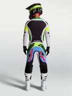 Alpinestars 2027 Supertech Dyna jersey en gear set, professionele motorcrossuitrusting voor heren, groen fluo en zwart, rugaanzicht met atletische pasvorm en stretch mesh-constructie