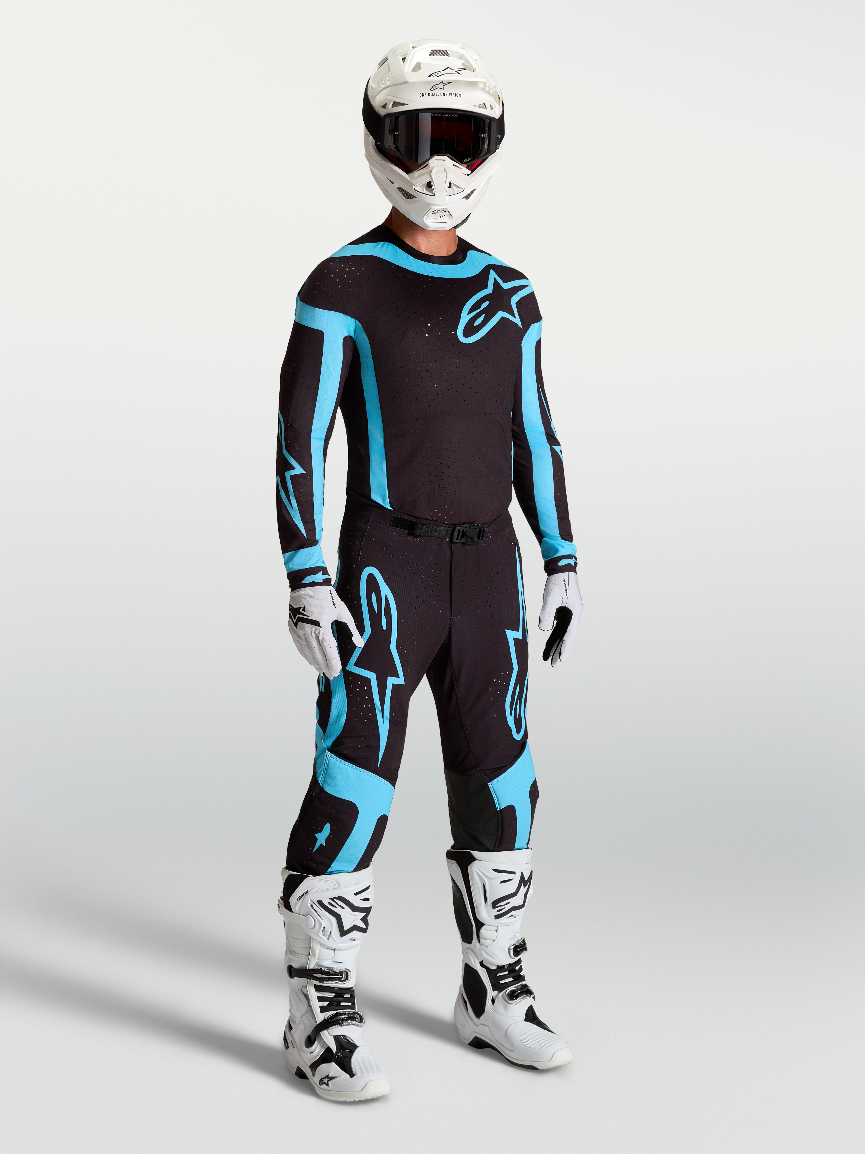 Alpinestars Supertech Vesta jersey en uitrustingsset, zwart en turquoise motorcross-outfit met een atletische racepasvorm.