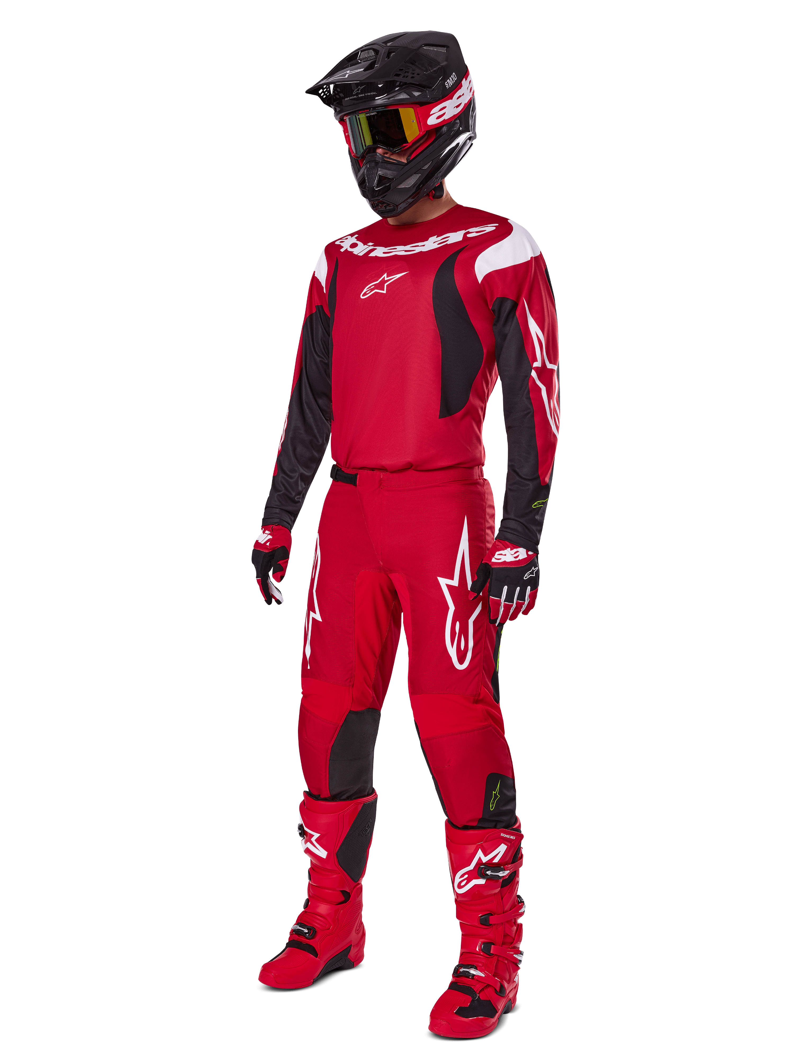 Motocross-Fahrer im Alpinestars 2025 Fluid Haul Gear Set, leuchtendes Rot mit schwarzen und weißen Akzenten, komplettes Outfit inklusive Trikot, Hose, Helm, Stiefeln und Handschuhen, entwickelt für Offroad-Performance und Schutz