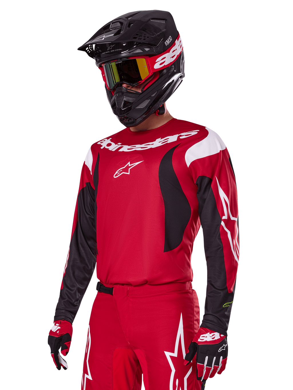 Pilote de motocross portant l'ensemble d'équipement Alpinestars 2025 Fluid Haul rouge, comprenant un maillot rouge avec des accents blancs et noirs, un pantalon rouge assorti avec des graphismes blancs, un casque noir avec logo blanc, des lunettes rouges et jaunes et des gants rouges et noirs, tenue de course de motocross coordonnée