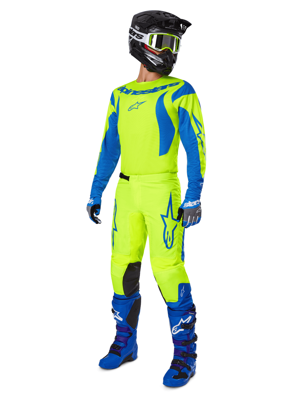 Alpinestars 2025 Fluid Haul motorcrossset, volledige motorcrossuitrusting met neongeel en blauw shirt en broek, zwarte helm, blauwe handschoenen en blauwe off-road laarzen, opvallende gecoördineerde outfit voor motorcross en enduro.