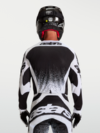 Alpinestars Techstar Swan jersey, motocrossjersey voor heren, zwart en wit, achteraanzicht met atletische racepasvorm.