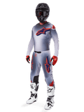Alpinestars 2025 Supertech Lipan Gear Set, Motocross Racing Gear, Gray with Orange Fluo and Navy Blue star graphics, worn with a black helmet, red and black gloves, and white and black boots, complete professional off-road outfit with ventilated design